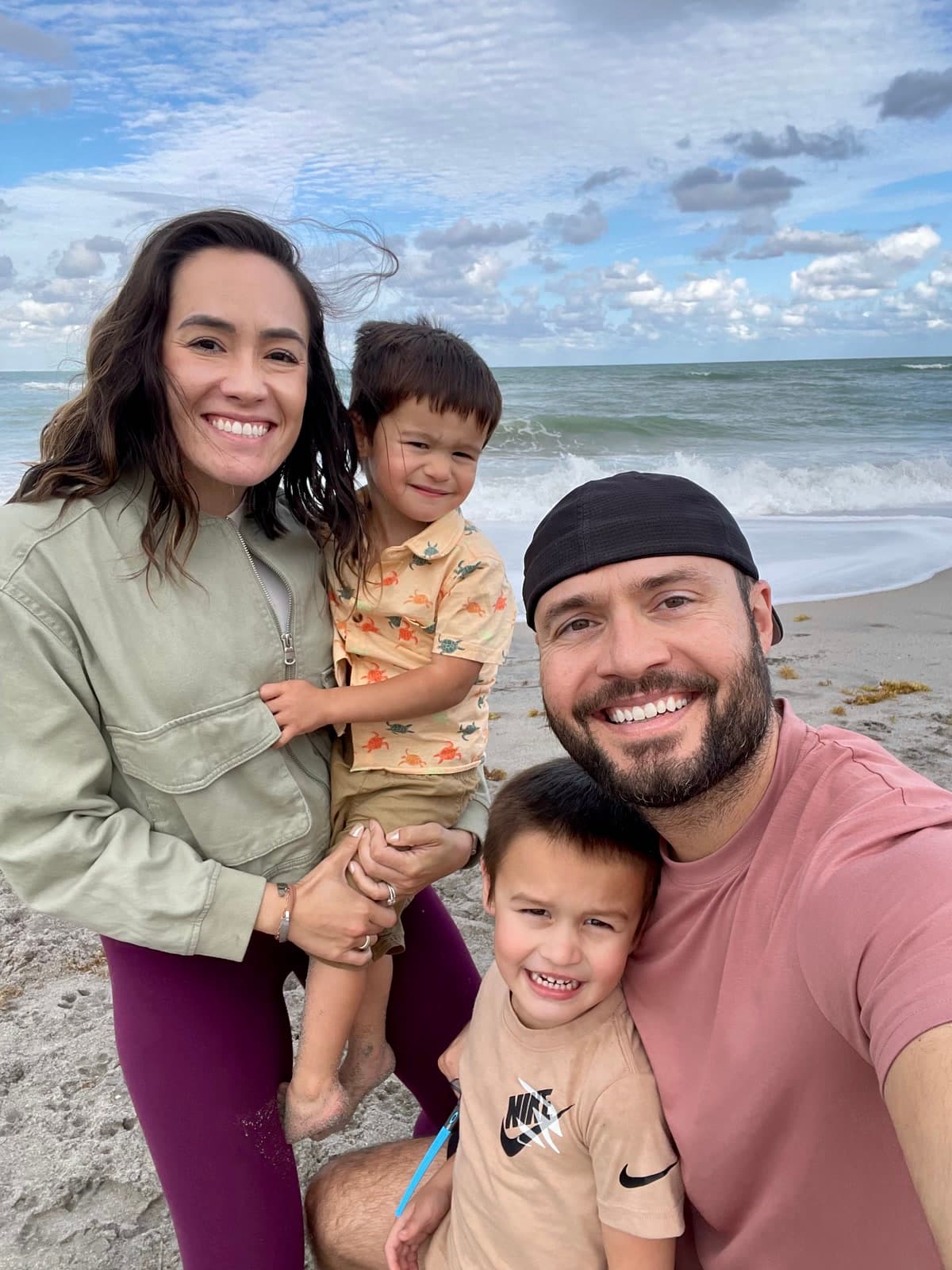 Dr. Rad and her family smiling together on the beach