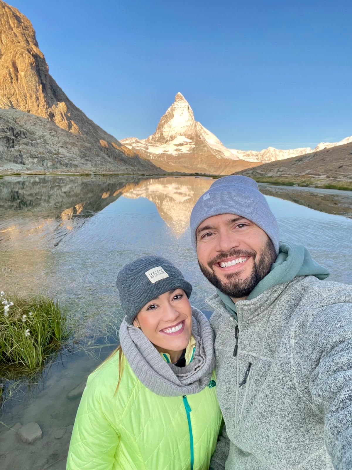 Dr. Rad and Stevan smiling in front of the Matterhorn and its lake reflection