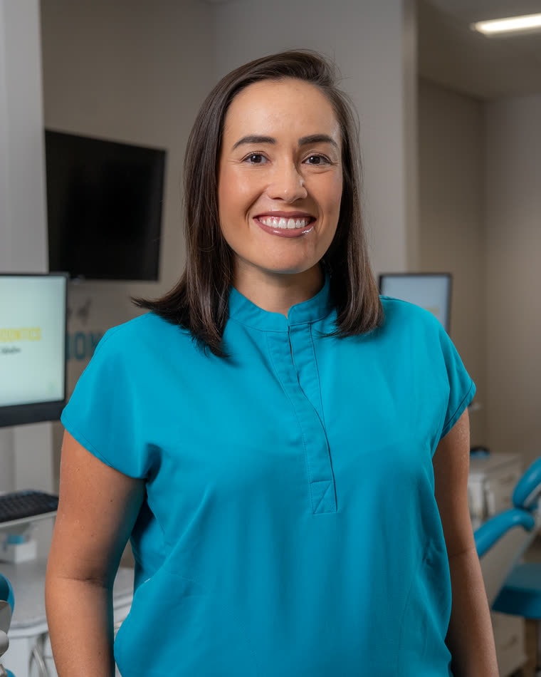 Dr. Marcela Radojevic in teal scrubs in the ION Orthodontics treatment bay in Port St. Lucie