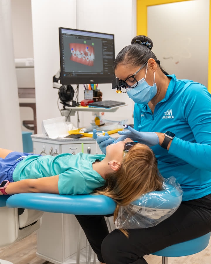 An ION Orthodontics clinician caring for a young patient during a treatment visit in Port St. Lucie